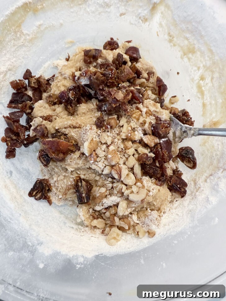 Chopped dates and nuts being folded into the finished batter.