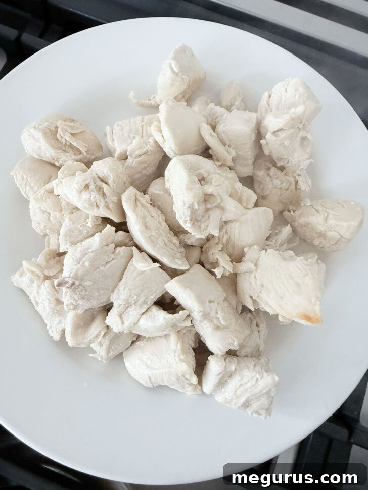 Cooked chicken pieces removed to a plate.