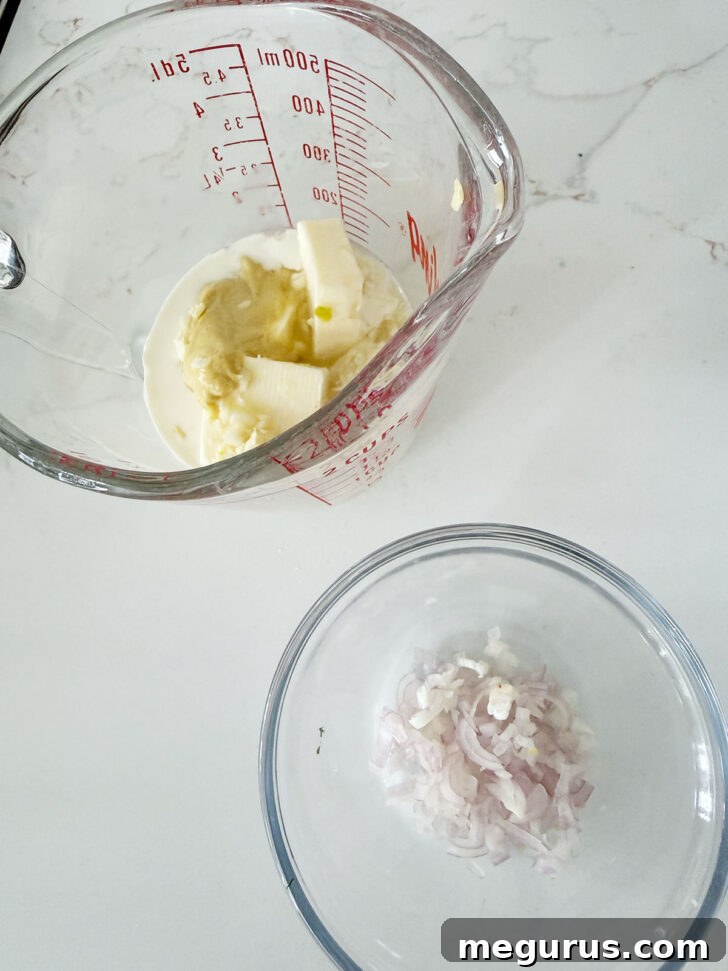 Bowls with finely diced shallots and creamy lemon sauce ingredients.