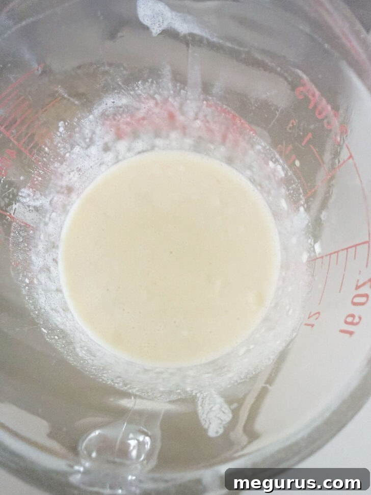 Creamy lemon sauce after being heated and stirred until smooth.