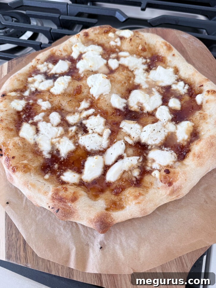 Fig jam and goat cheese after baking, showing the golden crust and melted cheese.