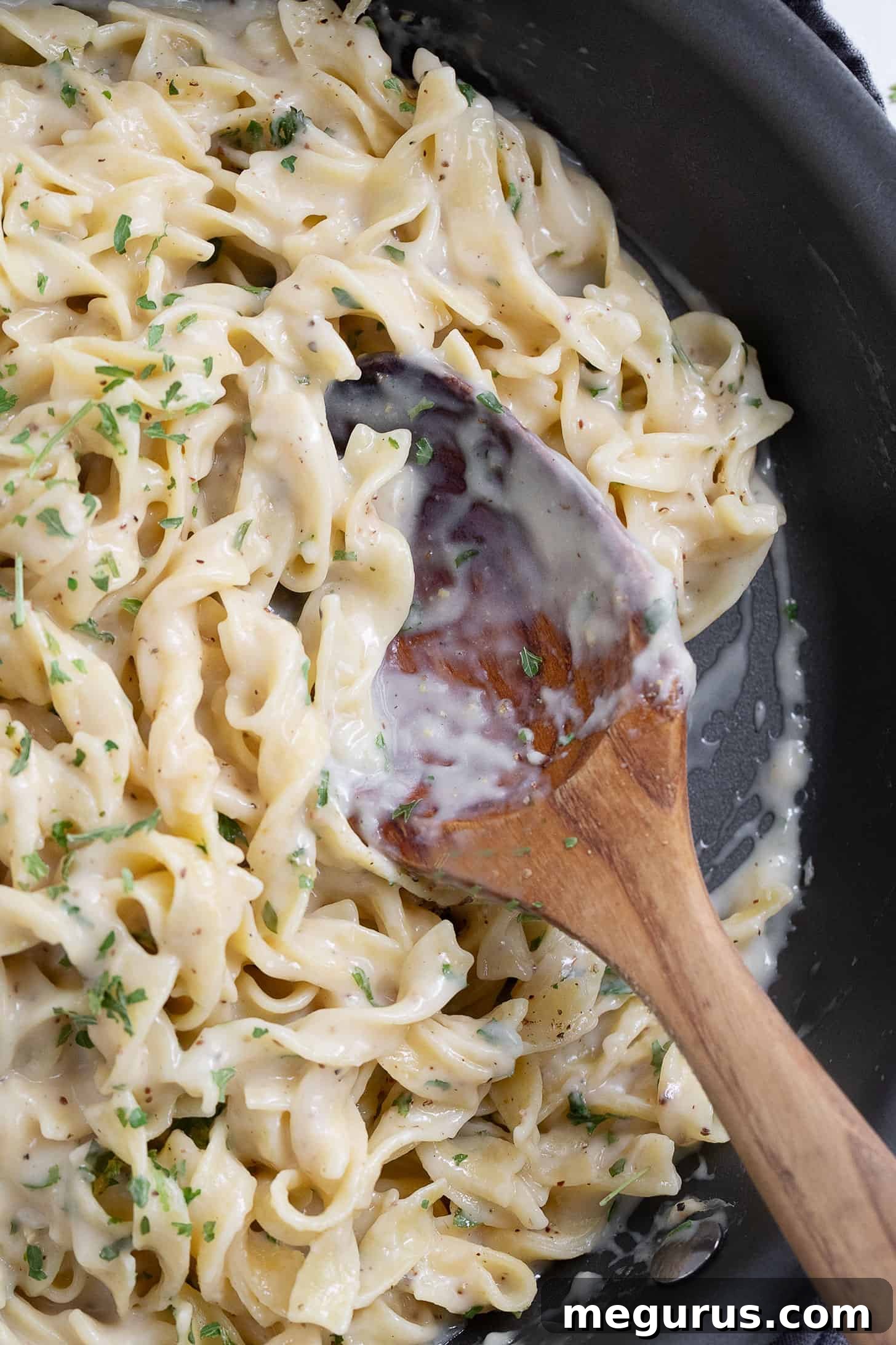 Creamy egg noodles without soup in a skillet.