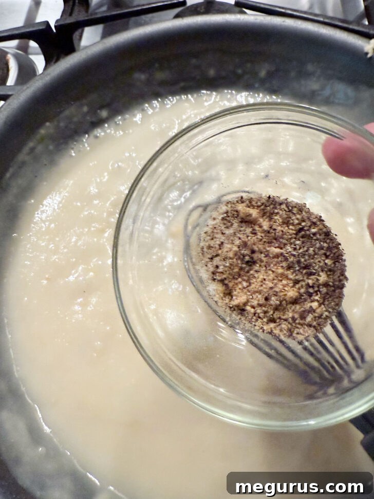 Adding spices to the skillet.