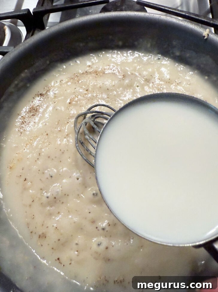 Adding milk to the skillet.