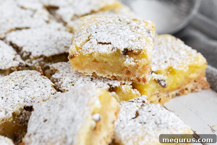 Lemon pistachio shortbread squares cut on a serving board.