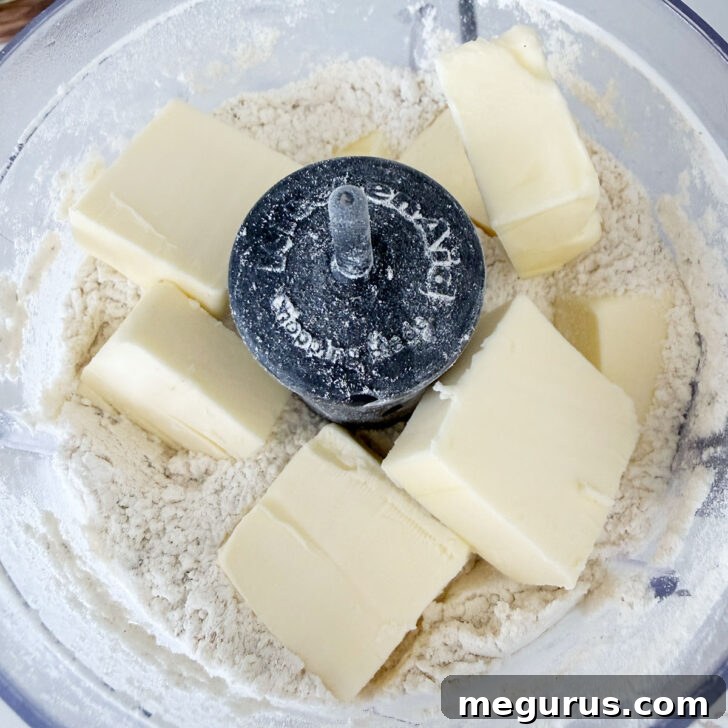 Cold butter cubes added to the food processor.