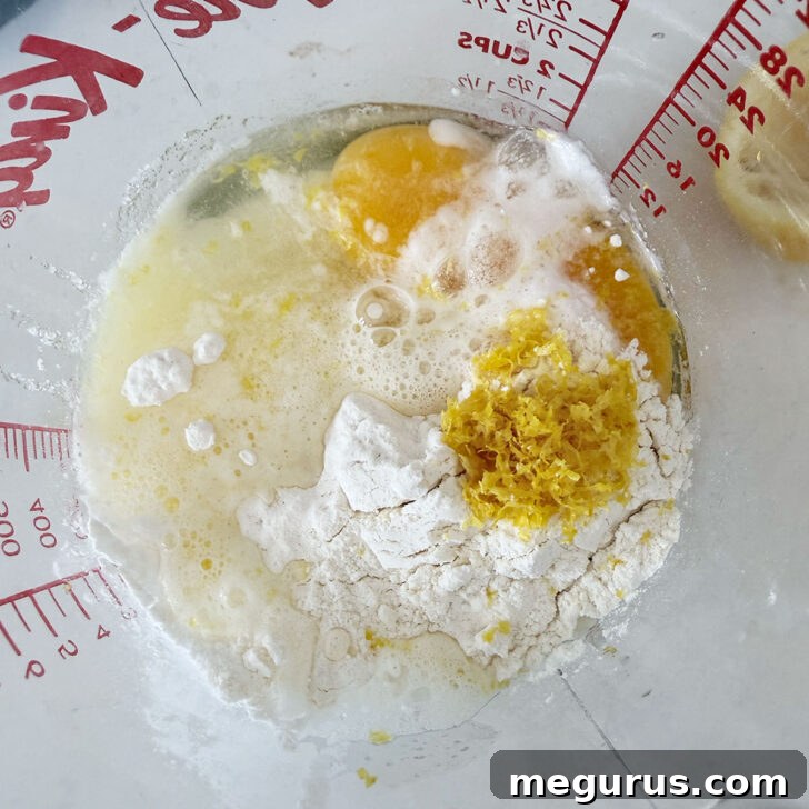 Adding the lemon filling ingredients to a measuring cup.