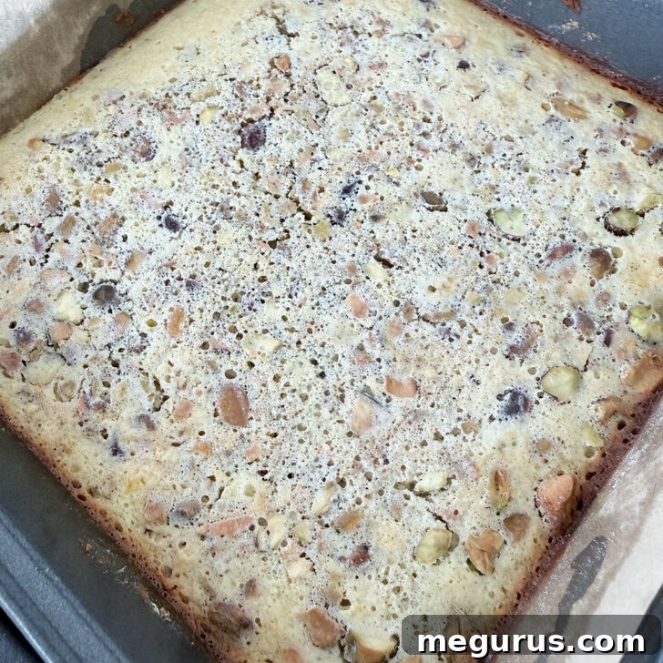 Baked lemon pistachio squares, cooled and ready for dusting.