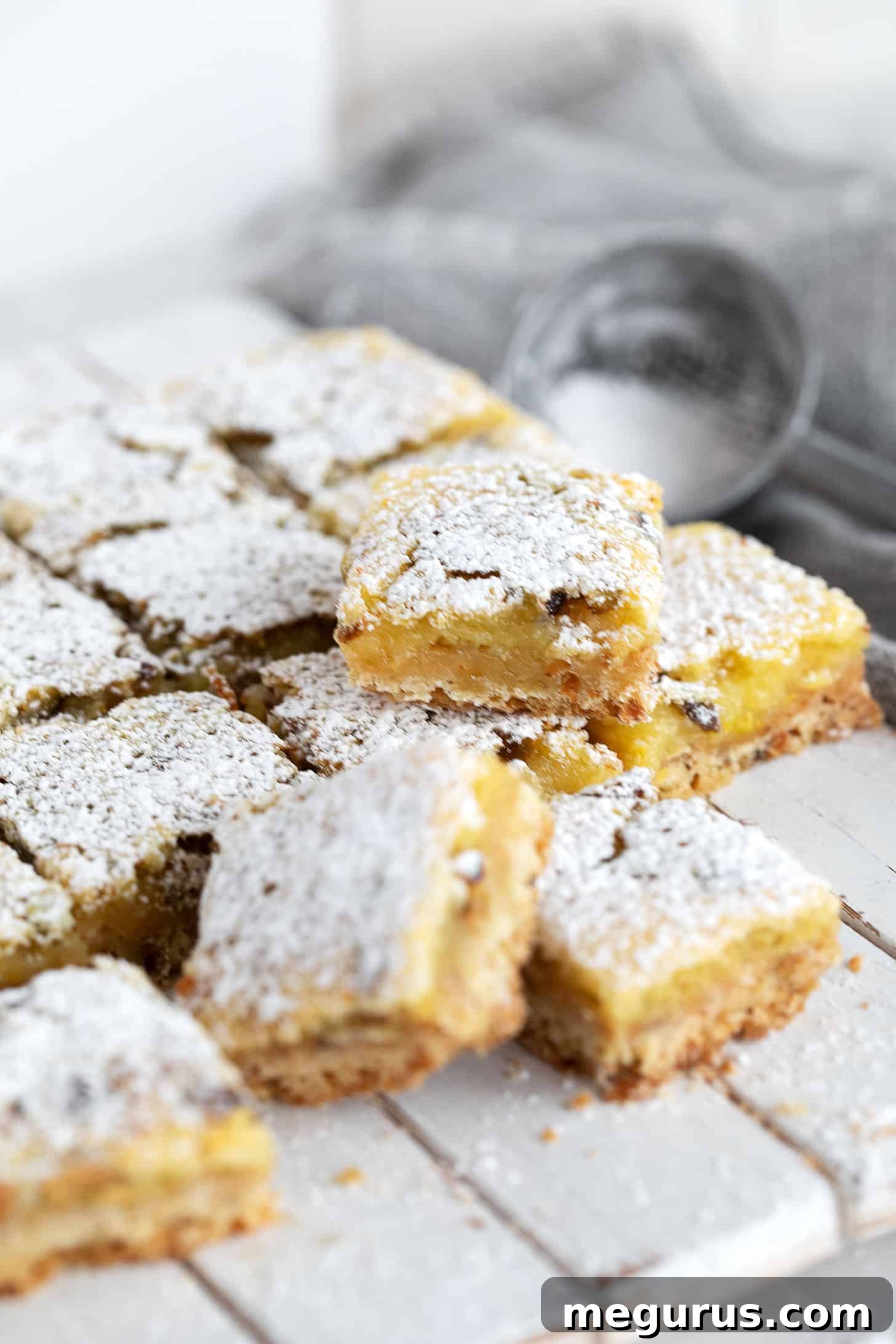 Lemon pistachio squares cut on a serving board.