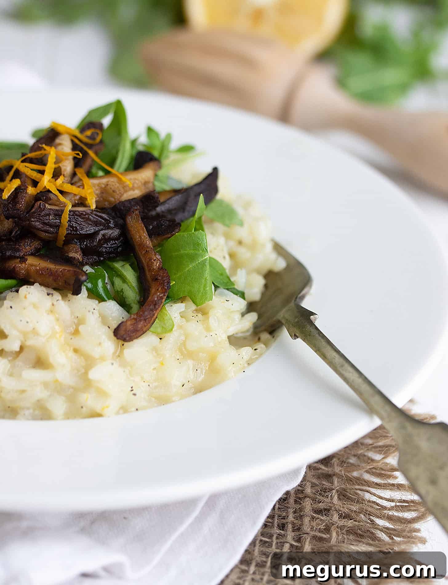 Close-up of a bowl of Lemon Risotto with Shiitake Mushrooms and wilted arugula