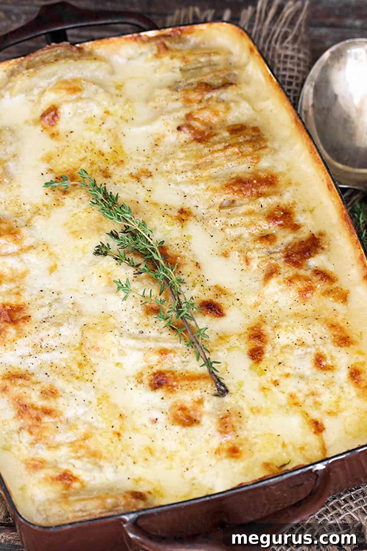 scalloped potatoes with bacon and cheese in casserole dish