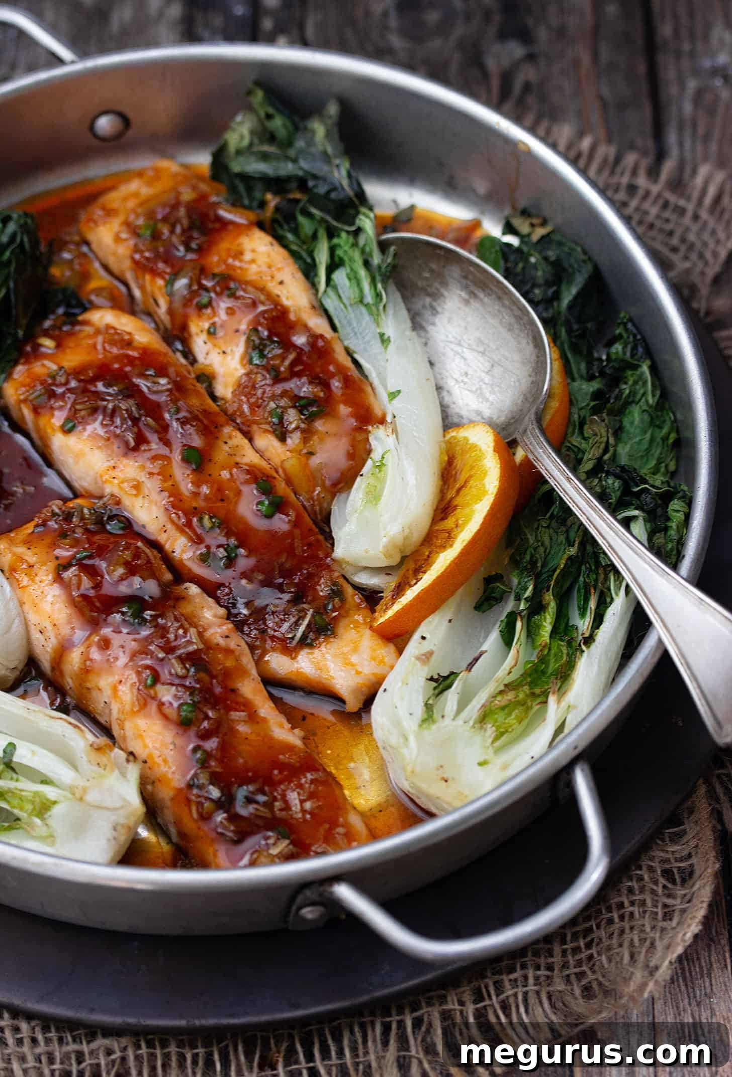 spicy orange salmon in baking dish with bok choy