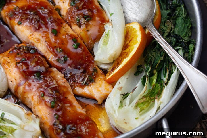 spicy orange salmon in baking dish with bok choy