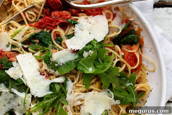 Blistered tomato pasta with mascarpone and arugula, served in a rustic bowl