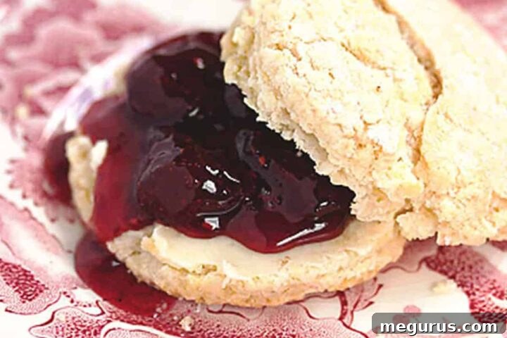 Strawberry Balsamic Black Pepper Jam beautifully arranged on a scone, inviting you to taste.