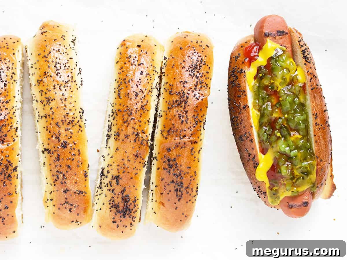 Perfectly baked, golden-brown New England style top-sliced hot dog buns arranged on a white background, ready to be filled.