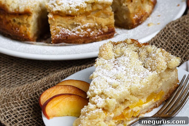 A delicious peach crumble cake on a serving plate