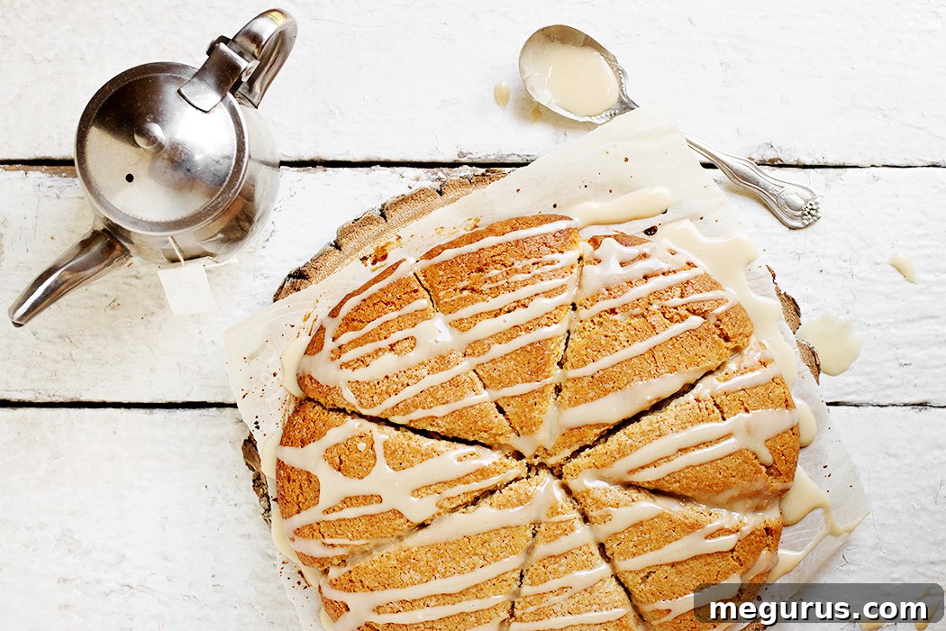 Golden brown French Toast Scones, drizzled with maple glaze, on a cooling rack.
