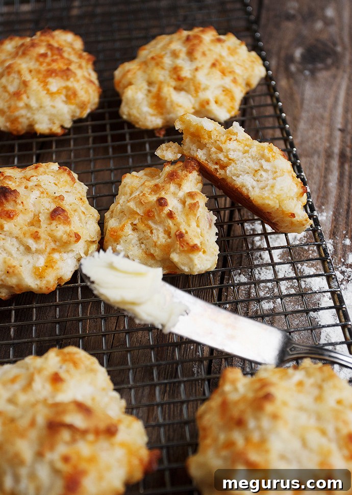 Close-up of freshly baked Easy Cheddar Apple Drop Biscuits, showing their golden crust and tender interior.