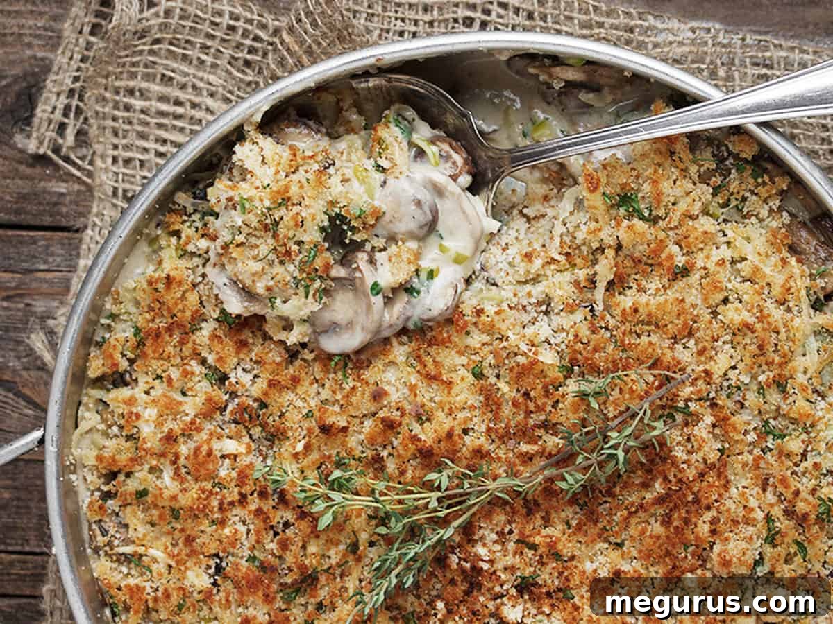 Creamy Leek and Mushroom Bake in a baking dish with a spoon, ready to serve