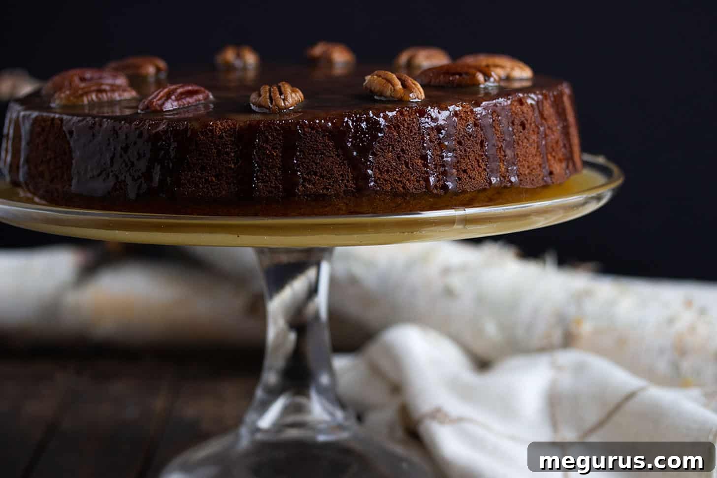 Decadent Pecan Banana Toffee Cake adorned with warm toffee sauce, ready to be served.