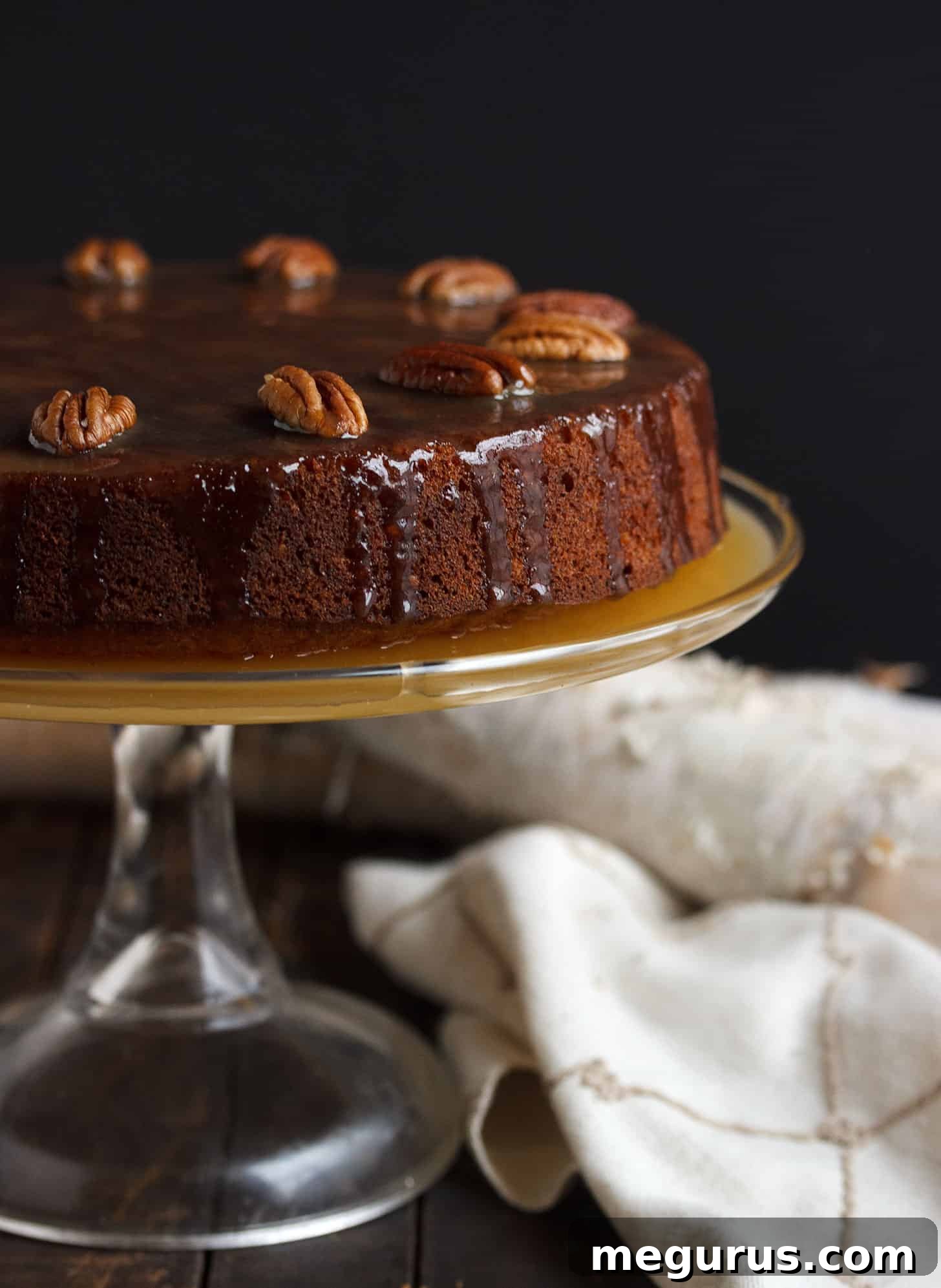 Close-up of a slice of Pecan Banana Toffee Cake, showcasing its moist texture and rich toffee glaze.
