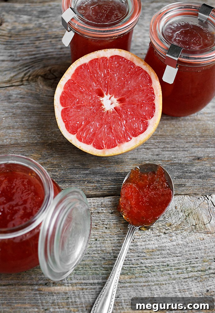 A spoonful of homemade grapefruit jam on a cold plate, demonstrating the wrinkle test for setting.