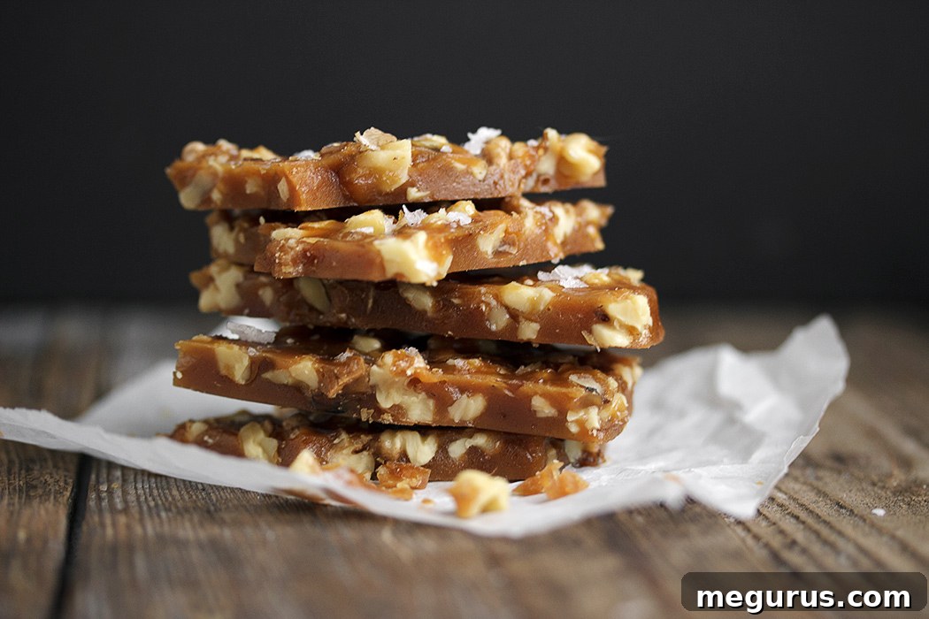 Salted Maple Walnut Brittle, showcasing its golden hue and crunchy texture with visible walnut pieces.
