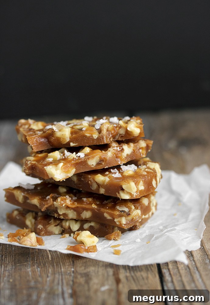 Close-up of Salted Maple Walnut Brittle, showing the clear, golden candy and embedded walnut pieces.