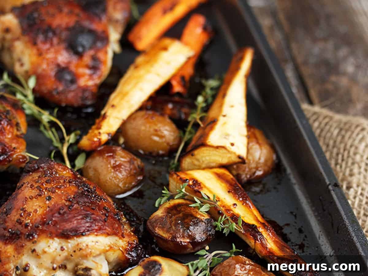 Sheet Pan Honey Mustard Chicken with vibrant roasted vegetables and crispy potatoes on a baking sheet, ready to serve.