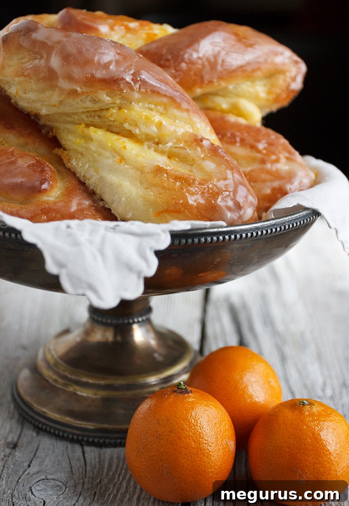Close-up of baked Glazed Bittersweet Orange Twists on a cooling rack