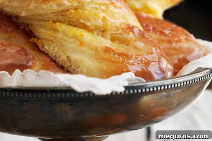 Glazed orange twists arranged on a silver cake stand