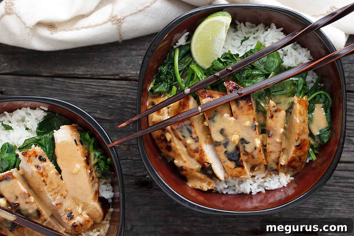Delicious Pork Rice Bowl with Peanut Sauce served in a bowl with chopsticks, ready to eat.