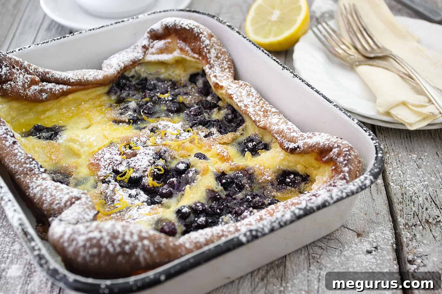 Golden brown Finnish Pannukakku fresh from the oven, studded with blueberries