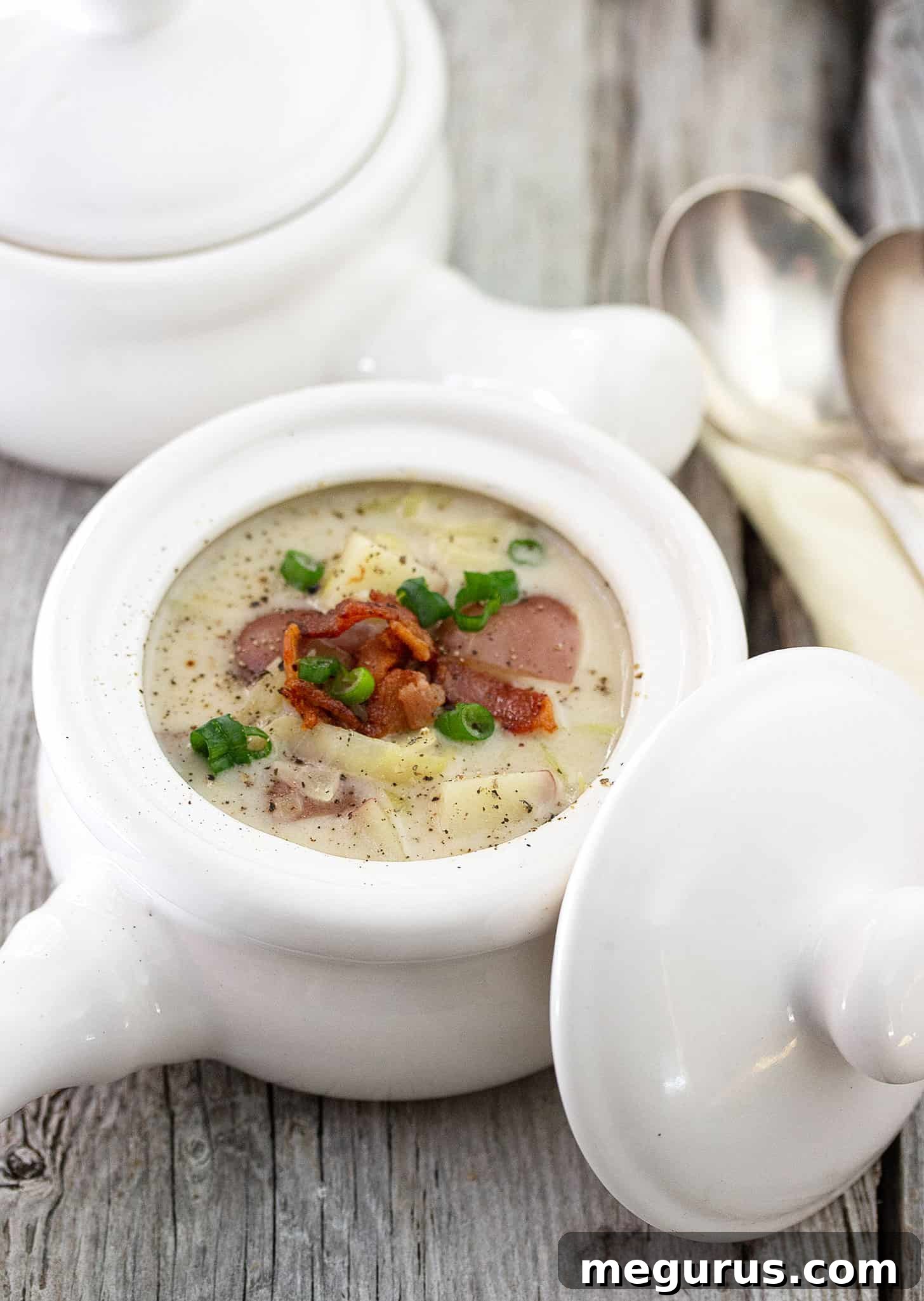 Close-up of creamy Colcannon soup with visible pieces of potato, cabbage, and leeks.