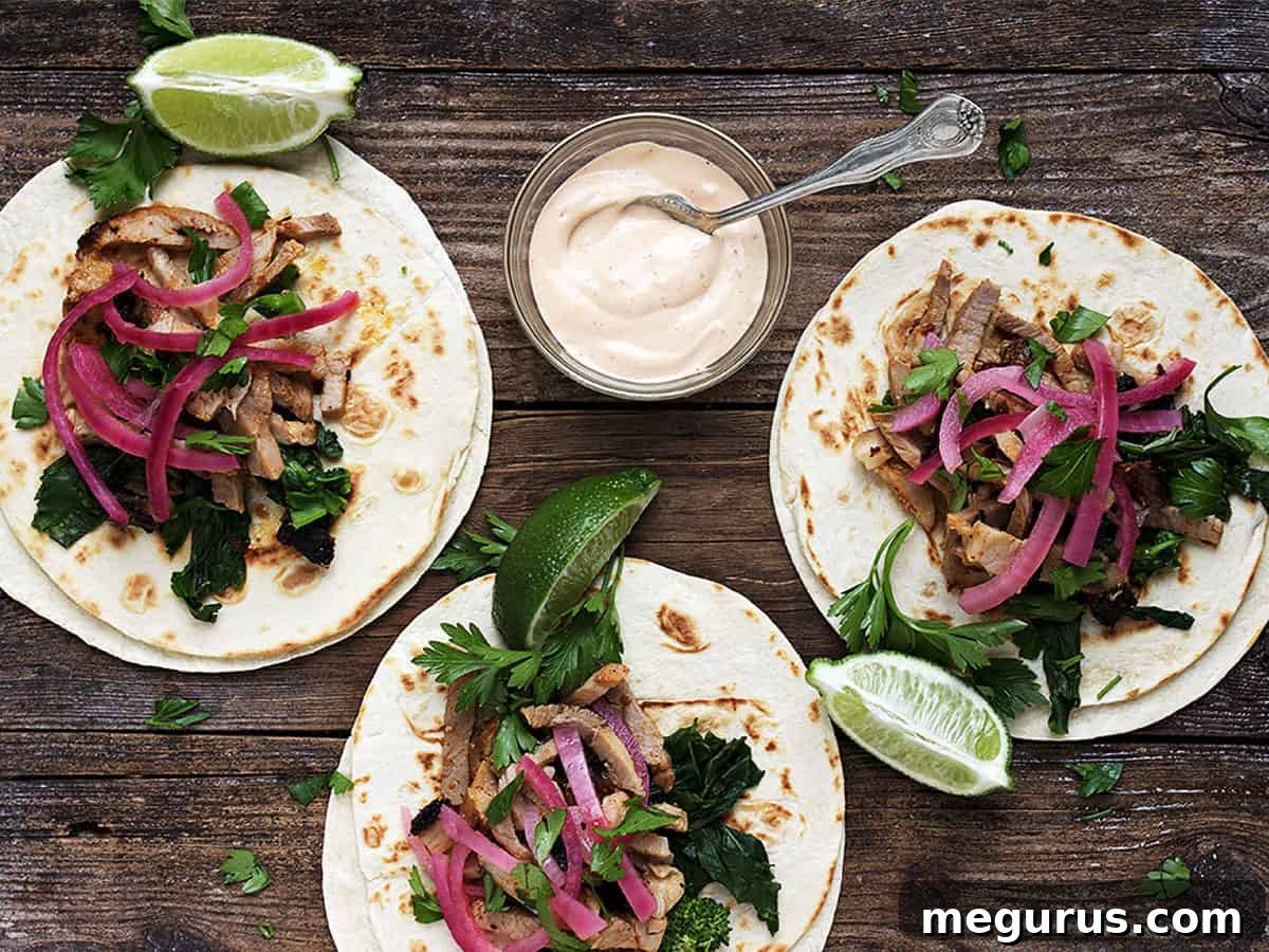 Crispy porchetta tacos with vibrant toppings on a rustic wooden board, ready to be enjoyed.