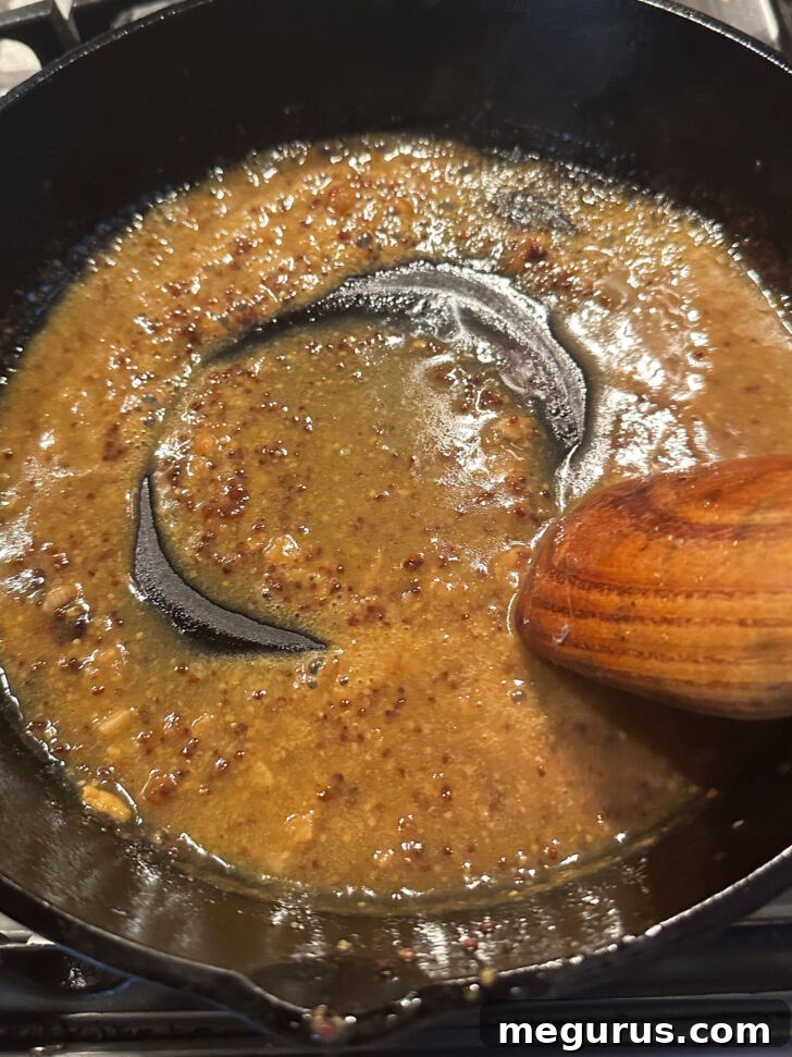 The finished, glossy, and rich pan sauce simmering in the skillet