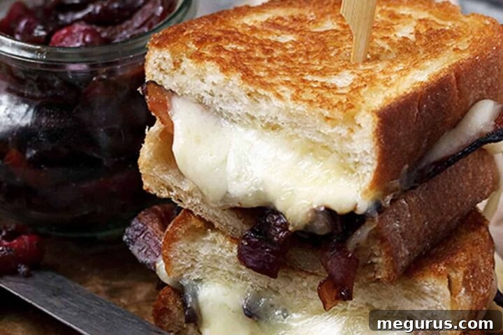 Gourmet cheese curd grilled cheese on a plate with a side of bacon marmalade.