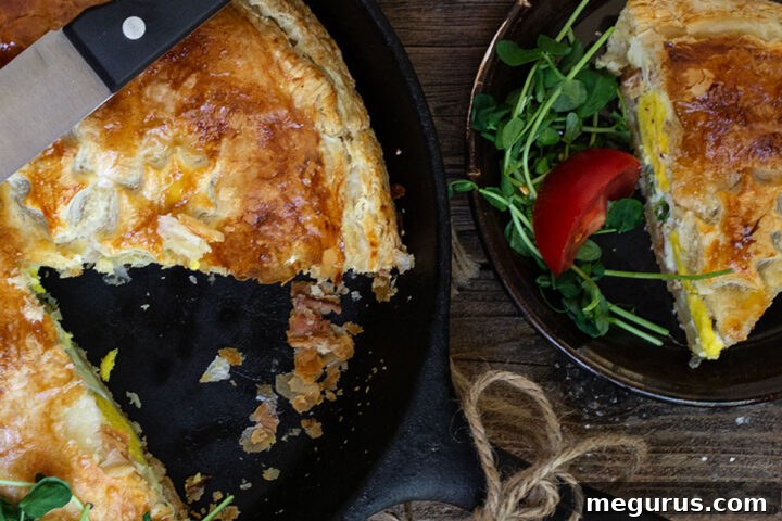 Skillet bacon and egg pie with a slice on a plate, ready to be served, highlighting its delicious crust.