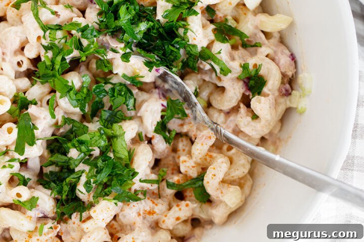 A beautifully presented bowl of creamy tuna pasta salad, ready to serve.