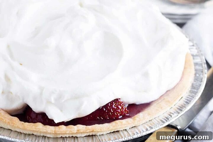 A beautifully presented Fresh Strawberry Glaze Pie on a cooling rack.