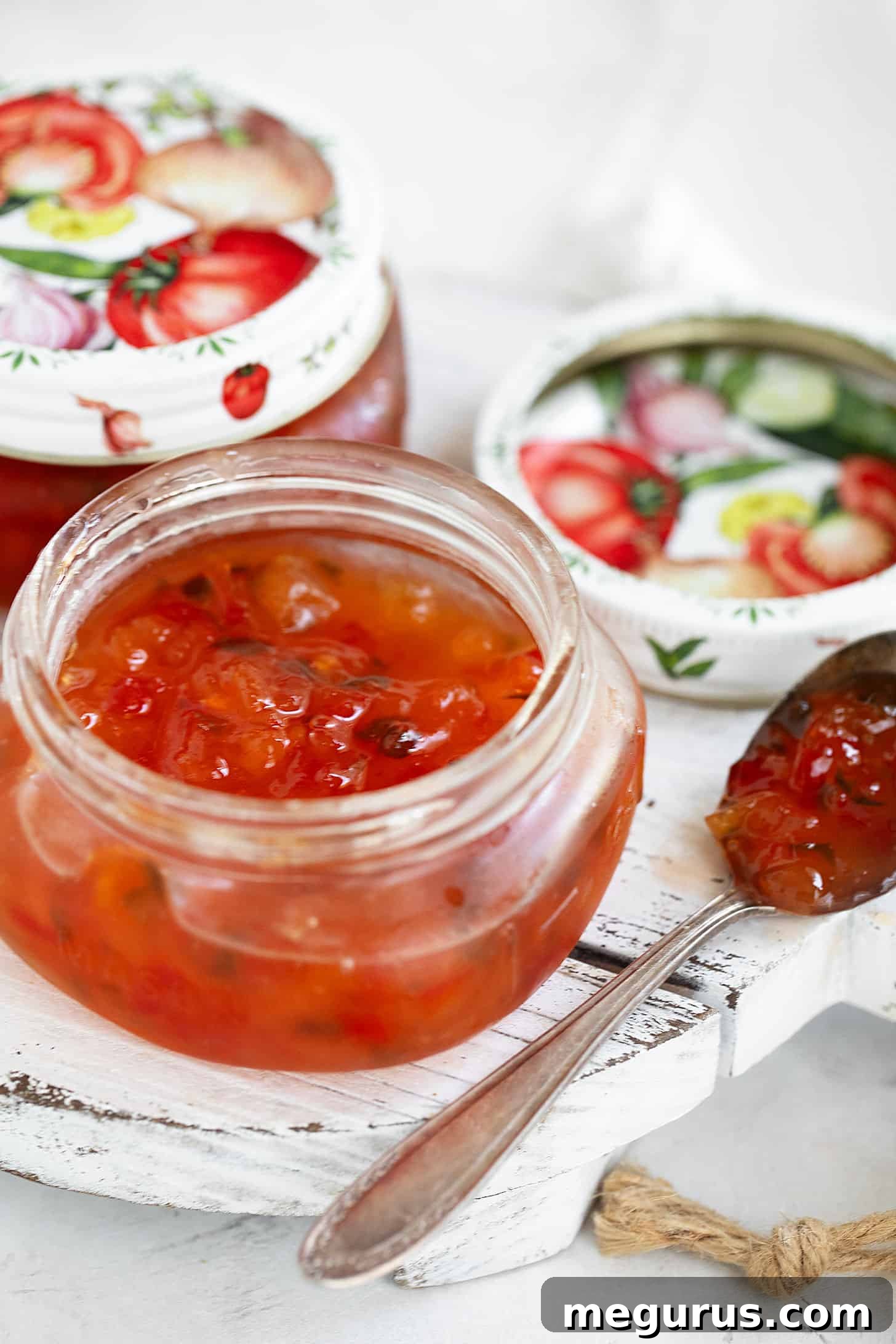 Several jars of homemade peach and pepper jam, ready for storage or gifting.