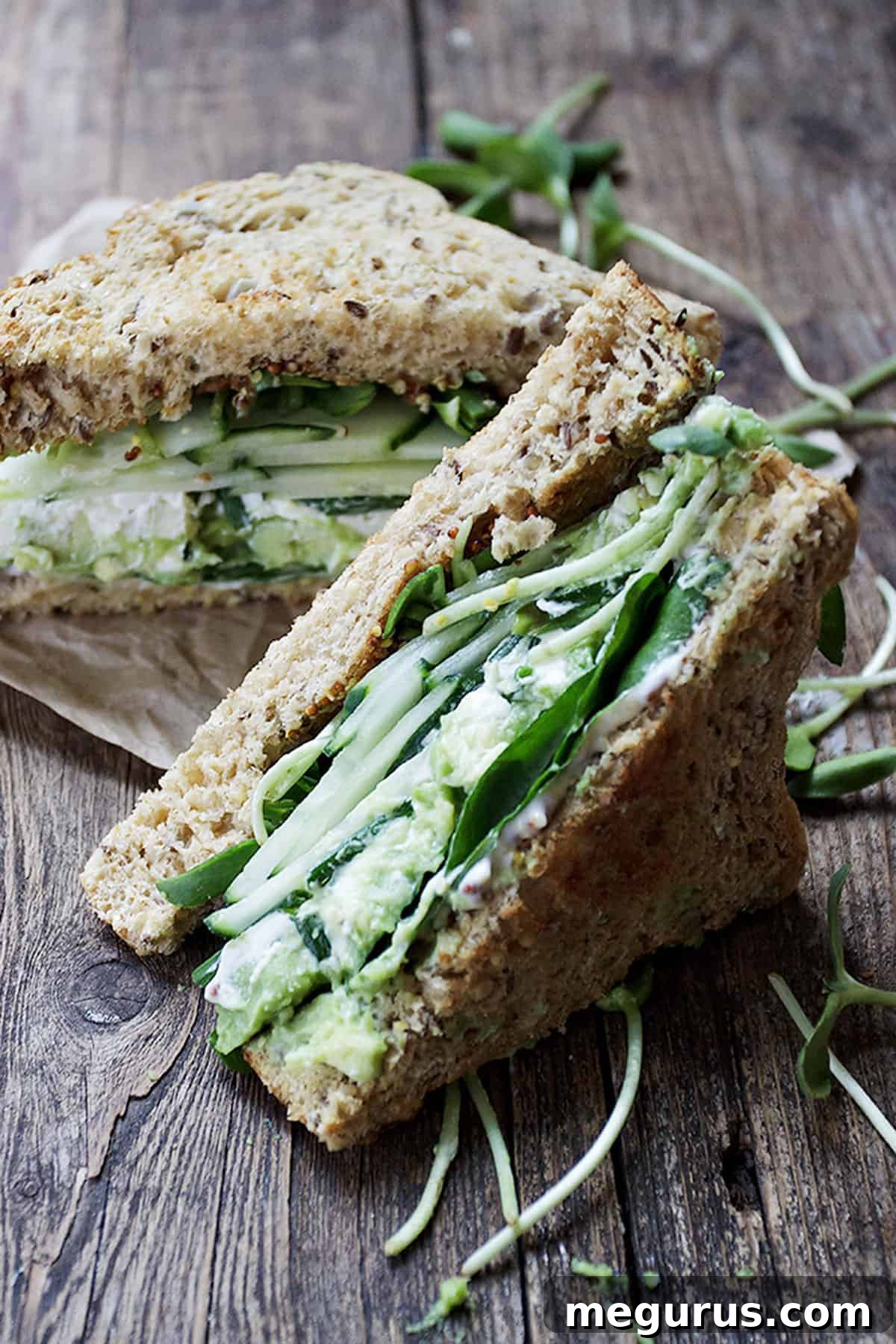 Green Goddess Sandwich on a rustic wooden background, close-up shot of layers