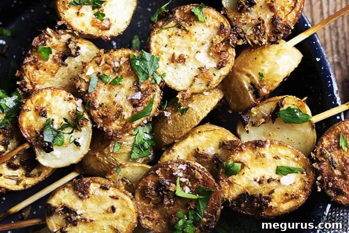 herb and garlic potato skewers in small skillet