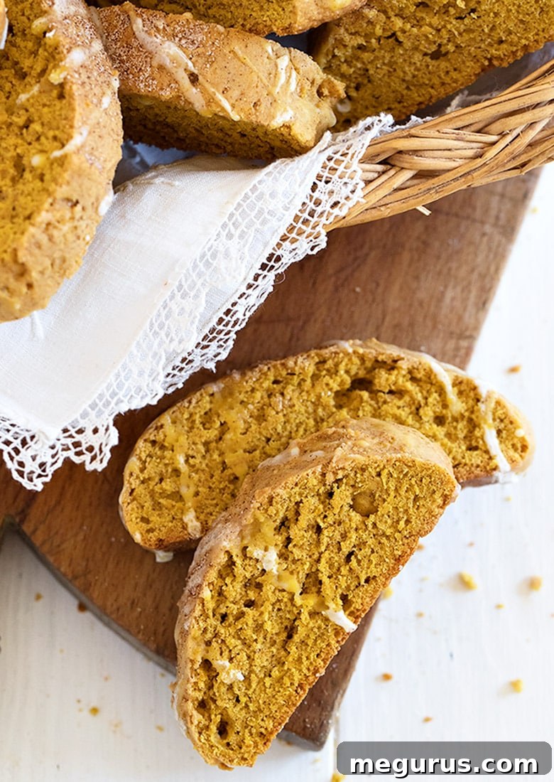 Autumn-themed basket filled with freshly baked pumpkin biscotti, drizzled with a sweet glaze, symbolizing a perfect fall treat.