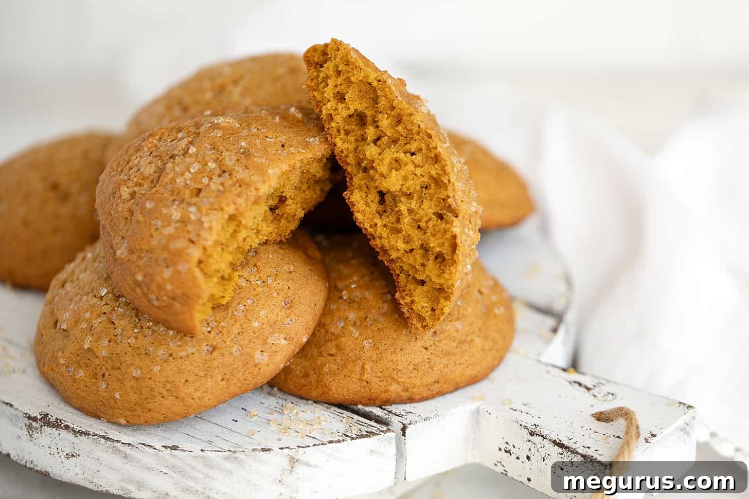 soft pumpkin cookies on serving board, decorated for fall