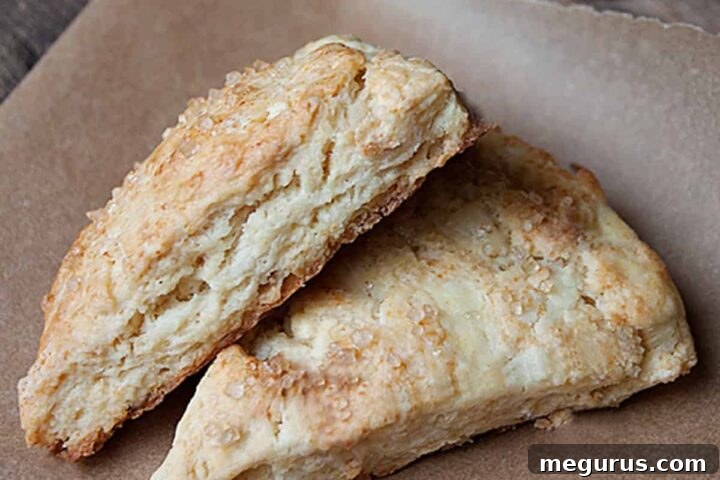 Beautifully baked dried apple scones on a cooling rack, glistening with a sugar topping.