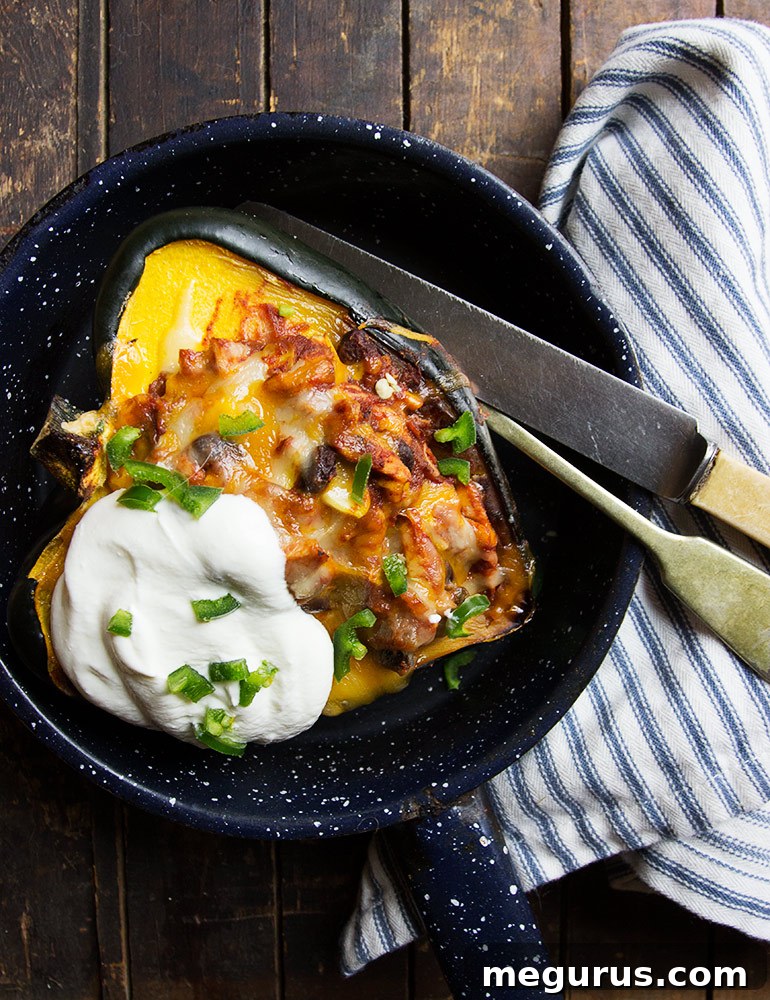 Close-up of baked Acorn Squash Enchiladas with melted cheese and fresh herbs