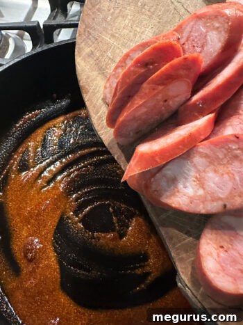 Adding chorizo to skillet with spice mixture.