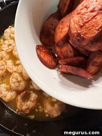Returning chorizo to the skillet.